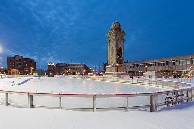 Clinton Square Ice Rink / Wikimedia Commons / Kenneth C. Zirkel 
Link: https://commons.wikimedia.org/wiki/File:Clinton_Square_skating_rink,_Syracuse,_New_York.jpg 
